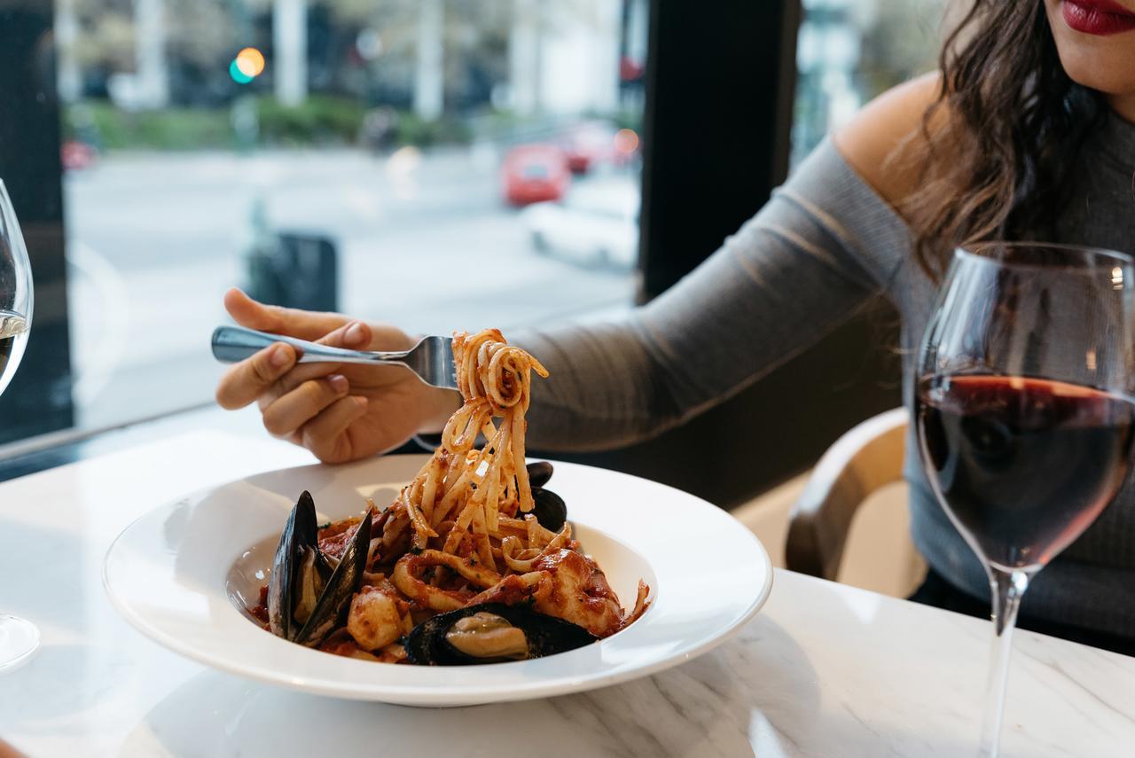 Art Series - The Chen Бокс Хил Екстериор снимка A woman eating a pasta dish